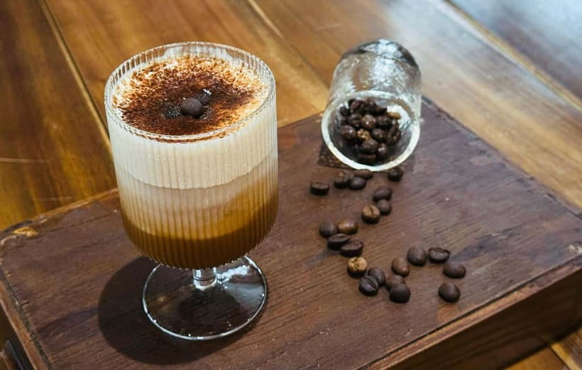 Layered Vietnamese salt coffee in a glass on a workshop counter