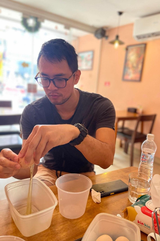 HCM: Egg Coffee Class with local Instructor & Snack - Drinking the finished cup with a snack